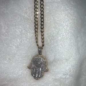 Real gold and diamond pendant and chain.